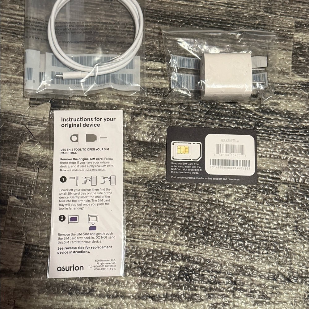 iPhone SE extra charger, SIM card and ejector tool.